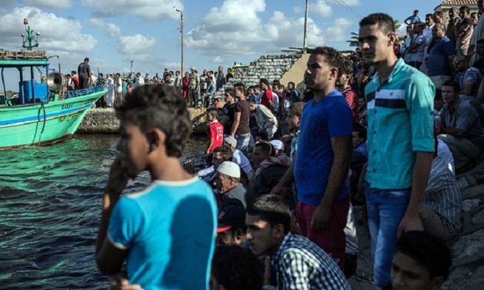 Crew members arrested after at least 50 migrants die when boat capsizes 